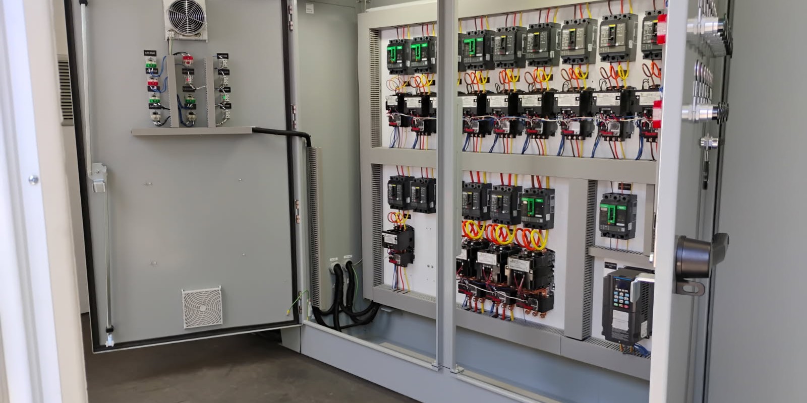 Two-bay motor control centre inside a Chapman-built container, Schneider breakers and contactors with door-mounted pilot devices