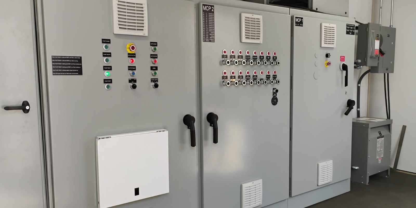 MCP 1 and MCP 2 control panels in a Chapman-built control room, plant start/stop station and conveyor indicators